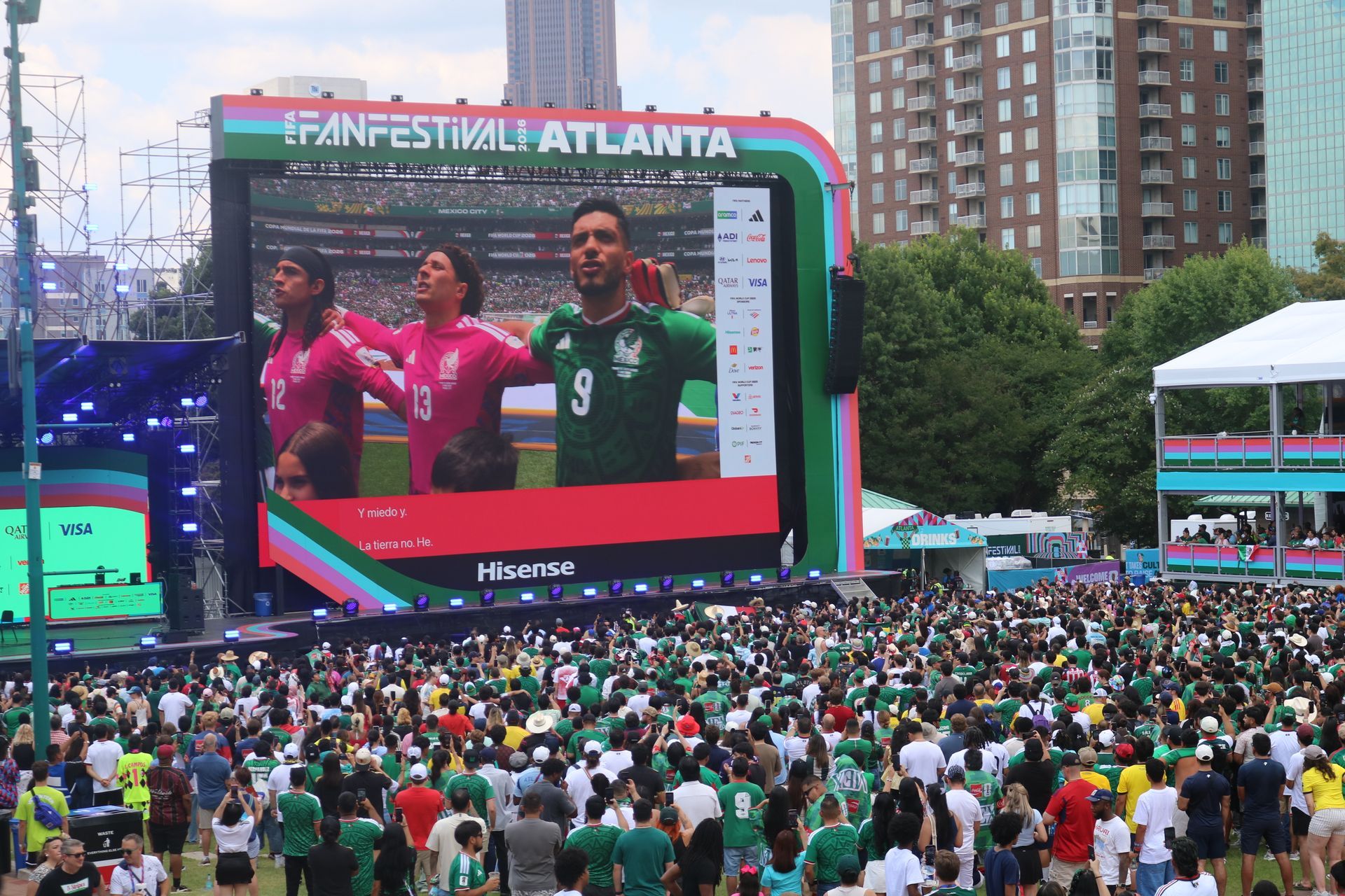 Large crowd watching a FIFA World Cup Atlanta fan festival on a giant outdoor screen