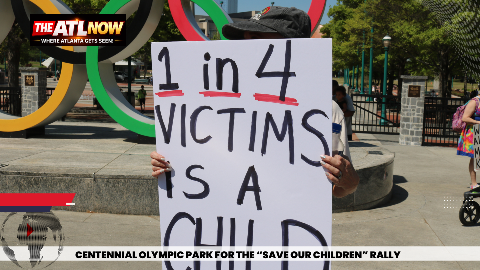 Protester holding sign reading “1 in 4 victims is a child” at Centennial Olympic Park rally