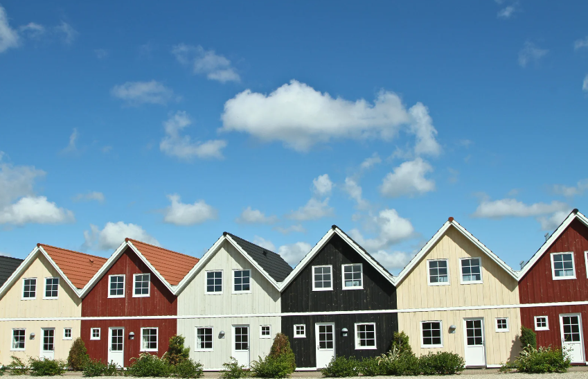 A row of houses with a blue sky in the background