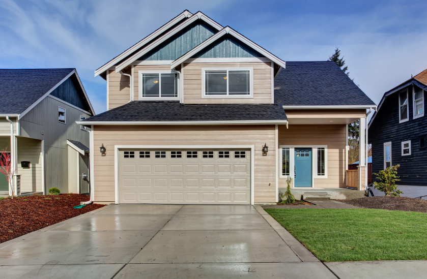A house with a large garage door and a blue door
