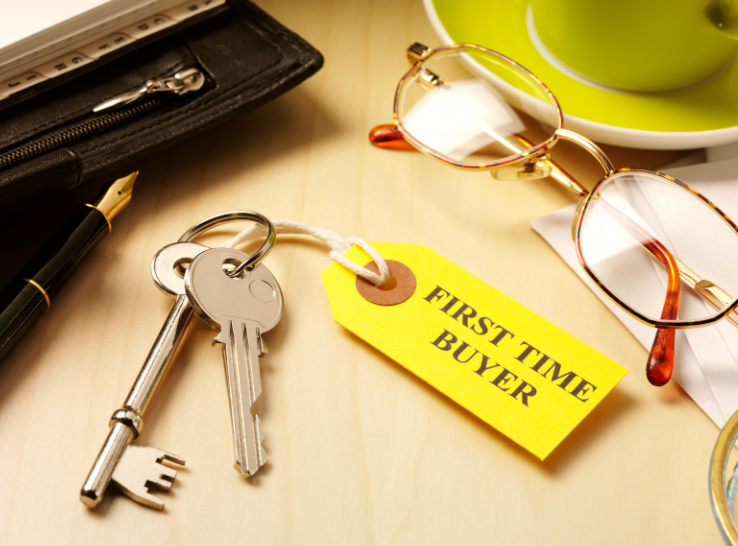 A pair of keys with a yellow tag that says first time buyer
