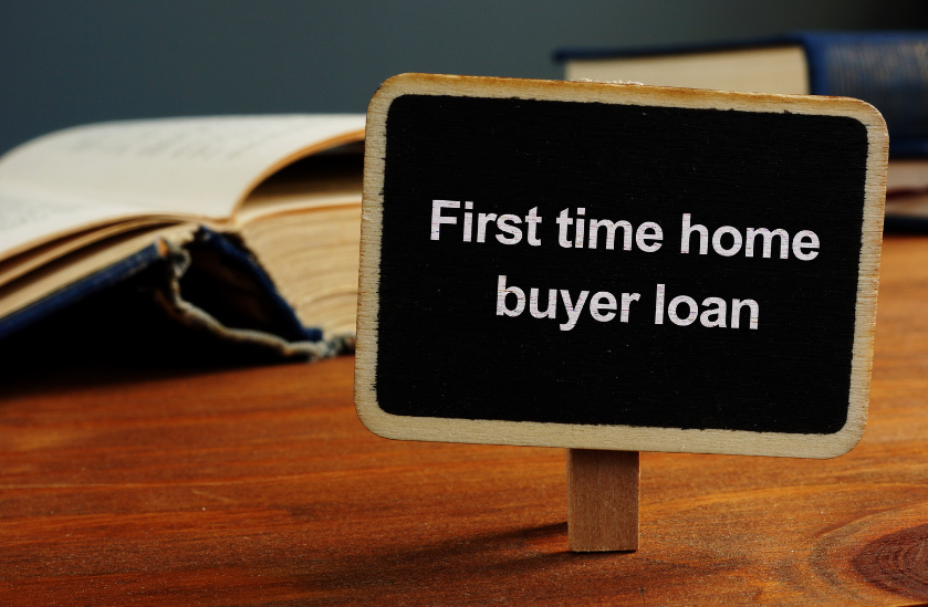 A small sign on a wooden table that says first time home buyer loan
