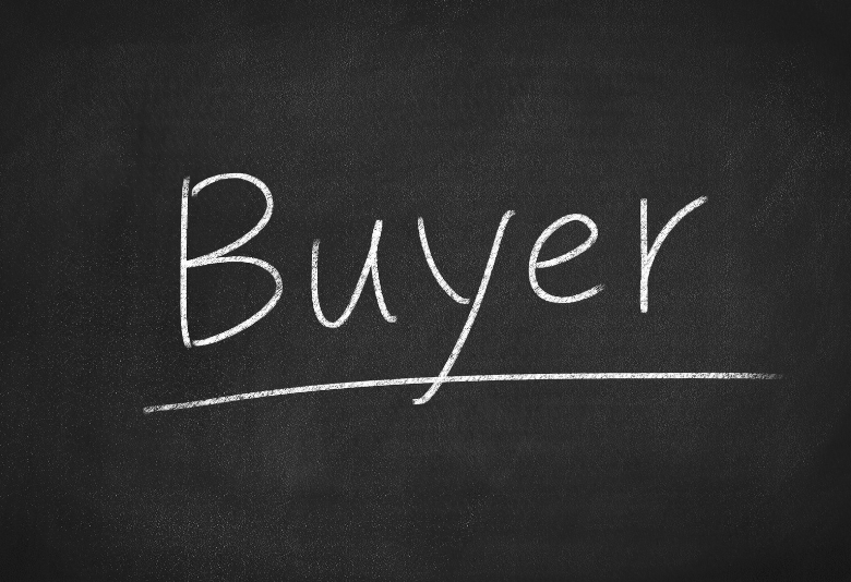The word buyer is written in white chalk on a blackboard