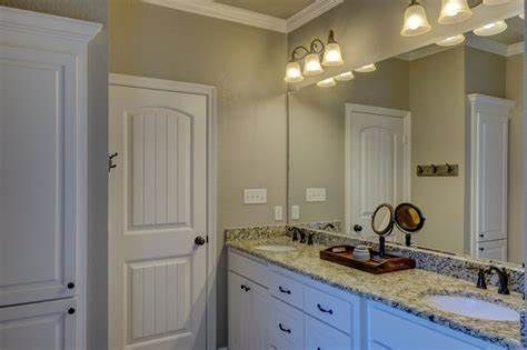 A bathroom with two sinks and a large mirror.