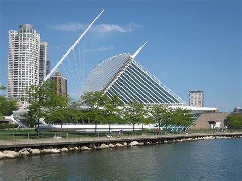 A large building sits next to a body of water