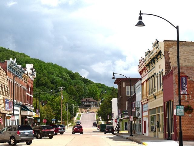 Cars are driving down a street in a small town