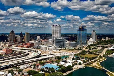 An aerial view of a city skyline with a lake in the foreground.