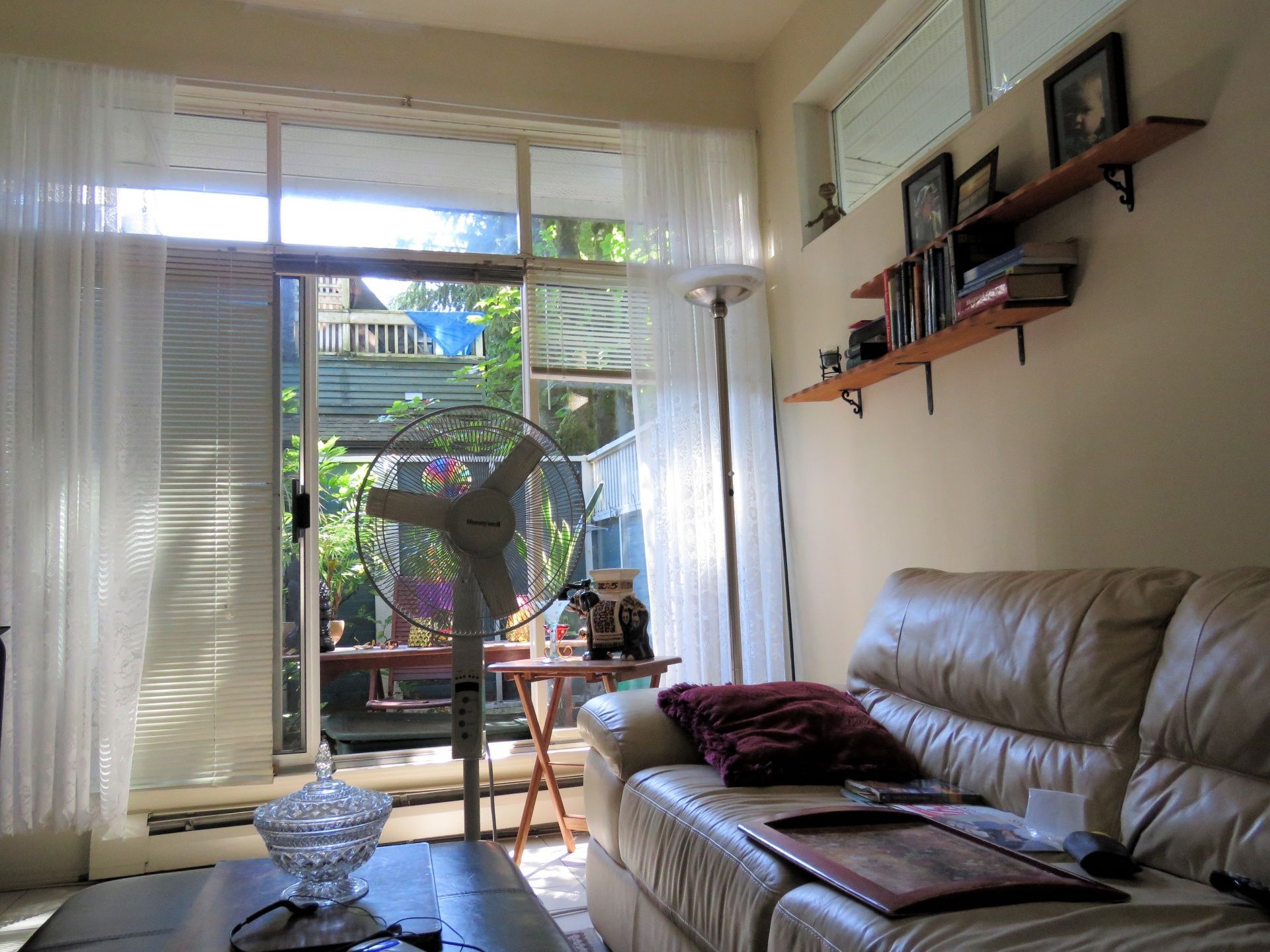 A living room with a couch and a fan