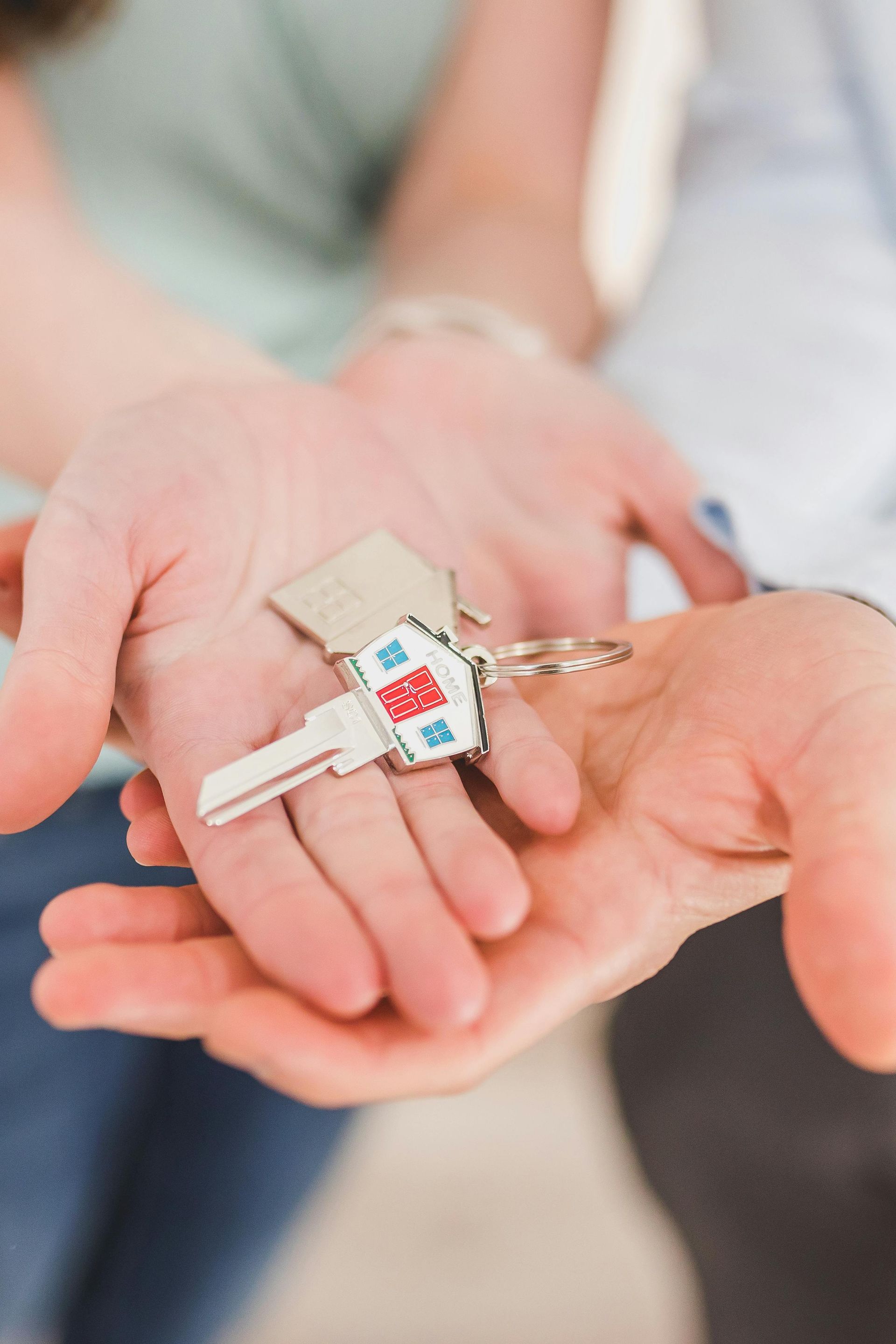 A man and a woman are holding keys in their hands.