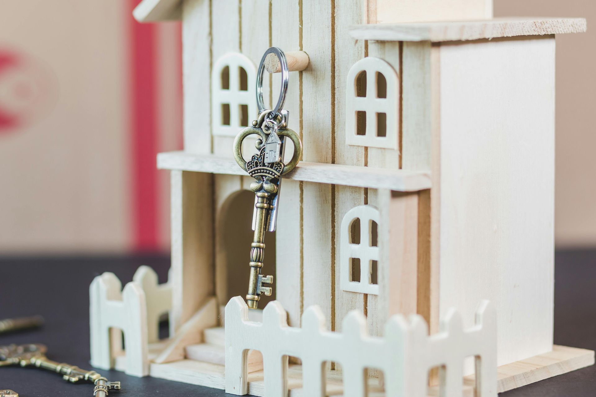 A wooden house with a key in the door.