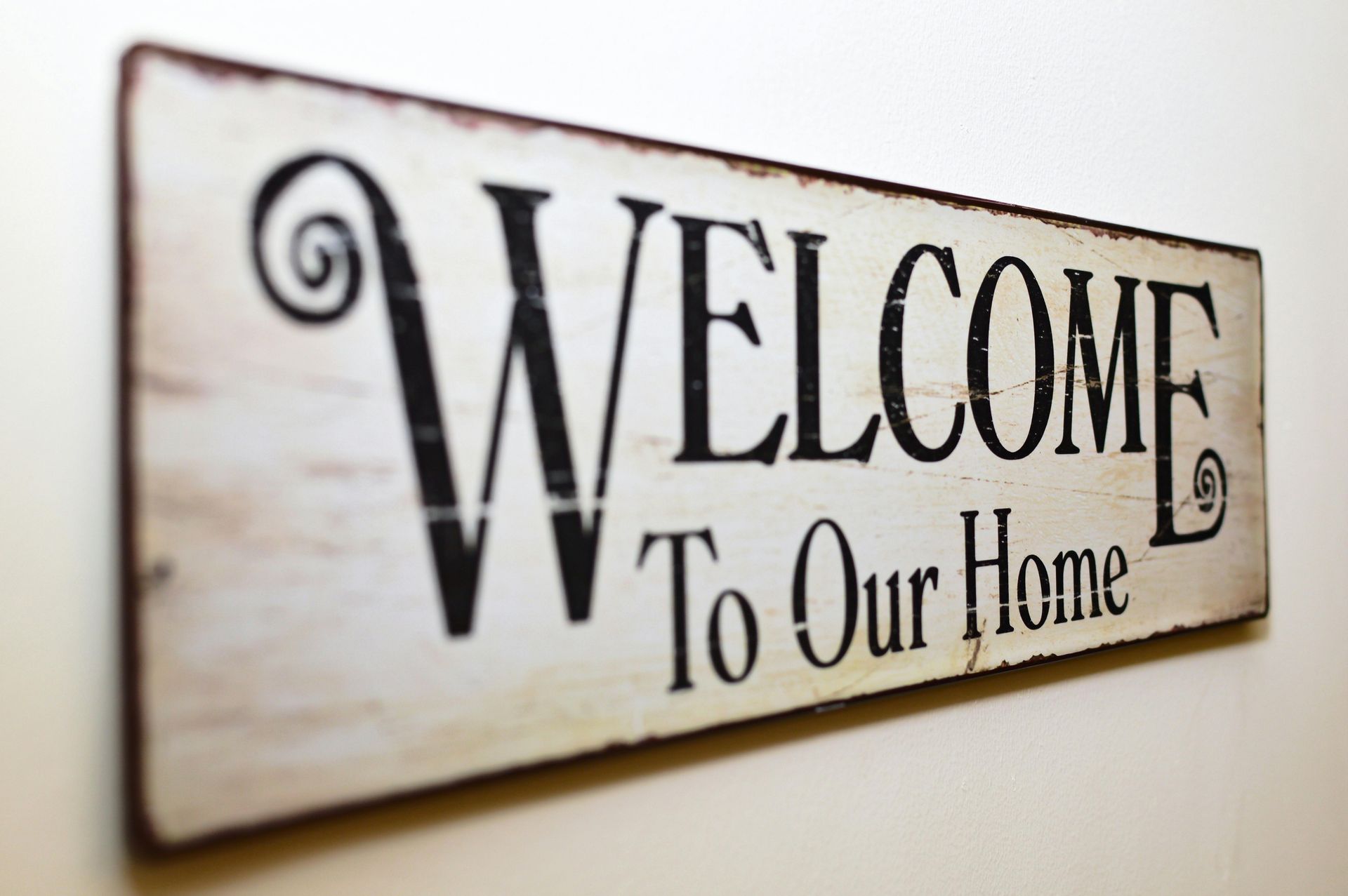 A sign on a wall that says welcome to our home