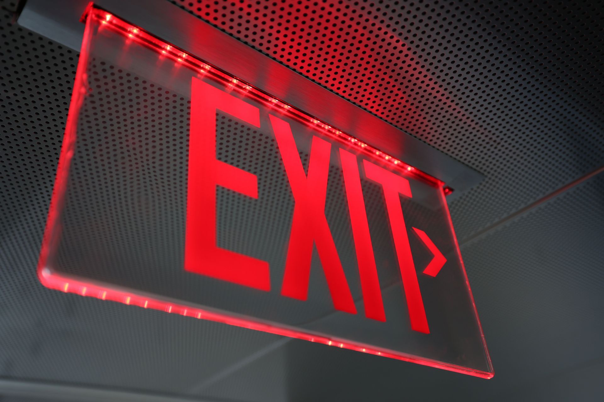 A red exit sign is hanging from the ceiling