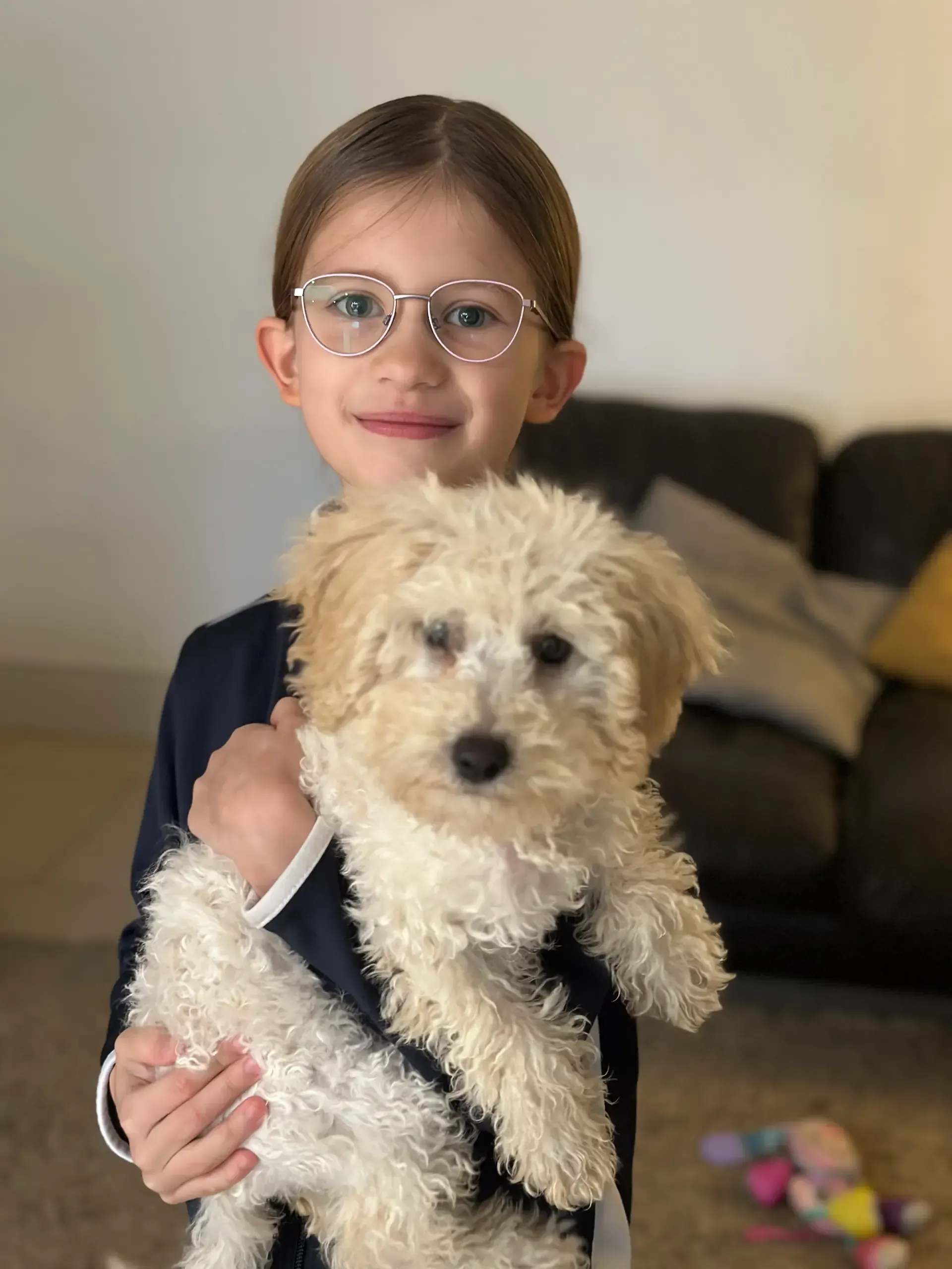 Harris Accountancy | A woman is hugging a dog in a living room.