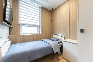 Private recovery room with bed