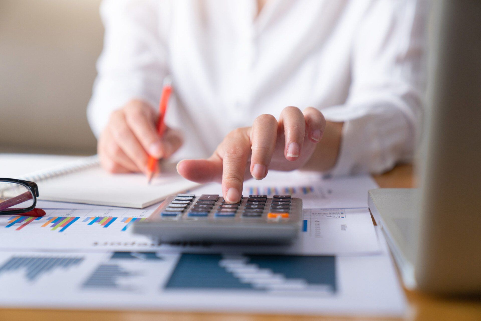 Businesswoman using calculator | Eastern Melbourne, VIC | Williams & Lay Lawyers