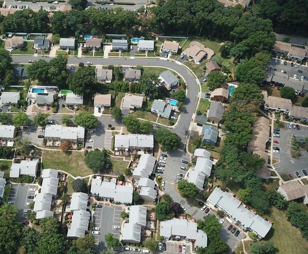 An aerial view of a residential area with lots of houses and trees