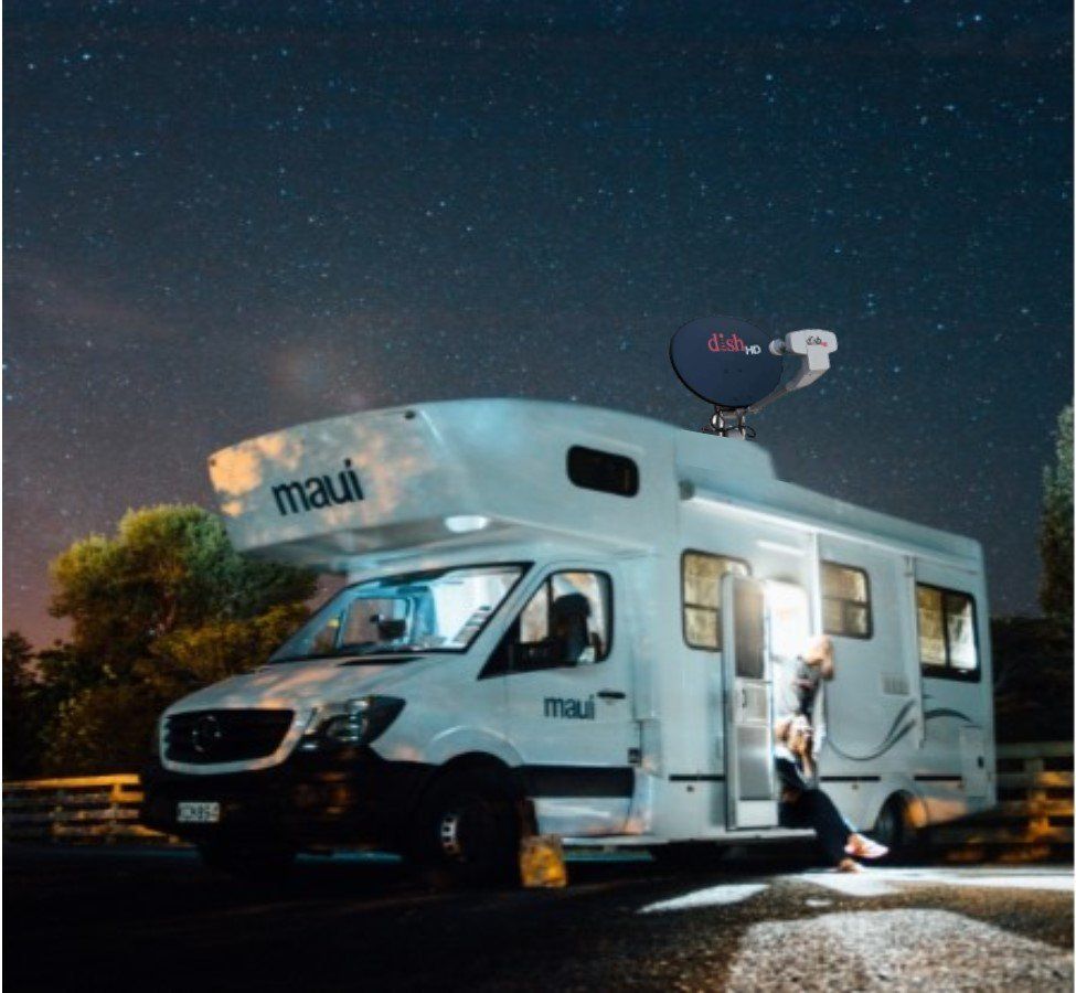 A white maui van is parked under a starry night sky