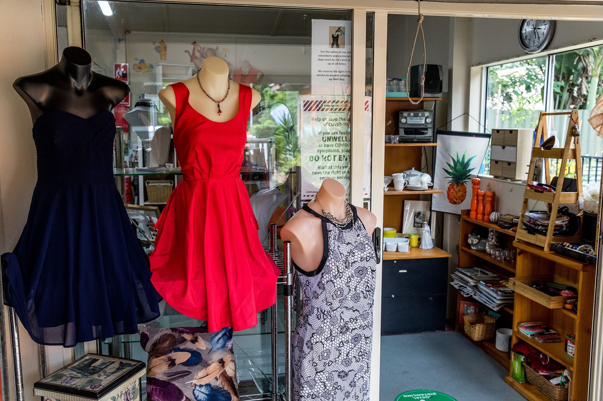 A red dress is on a mannequin in a store