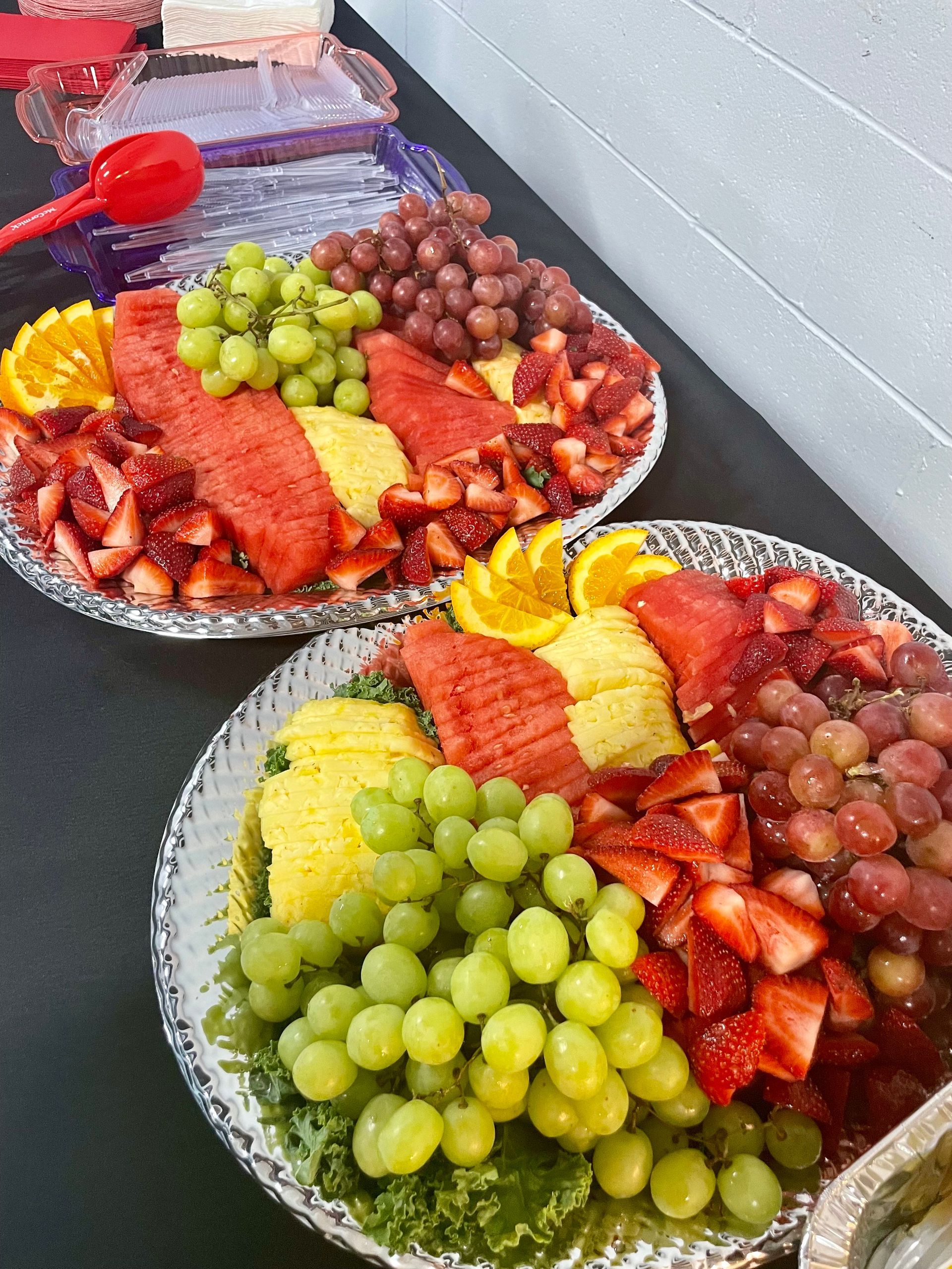A wooden cutting board topped with a variety of appetizers. A wooden cutting board topped with a variety of appetizers.