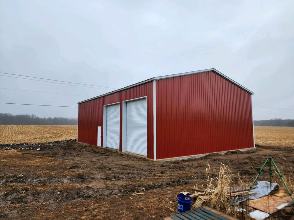 A red barn in the middle of a field
