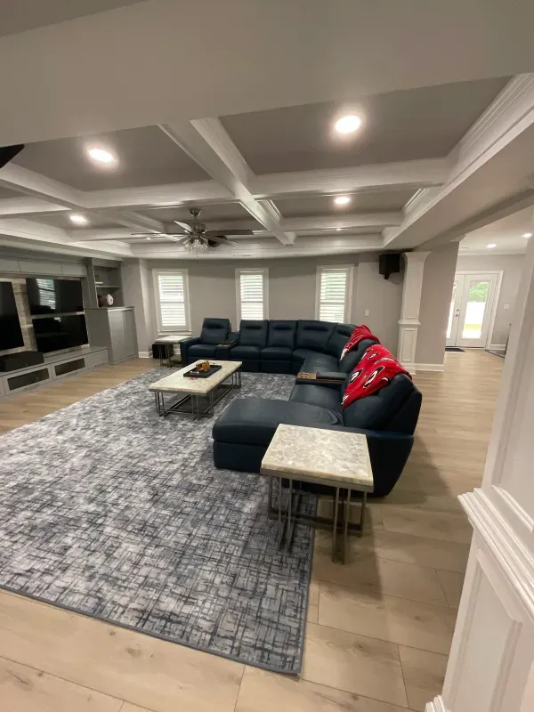 A living room filled with furniture and a rug.