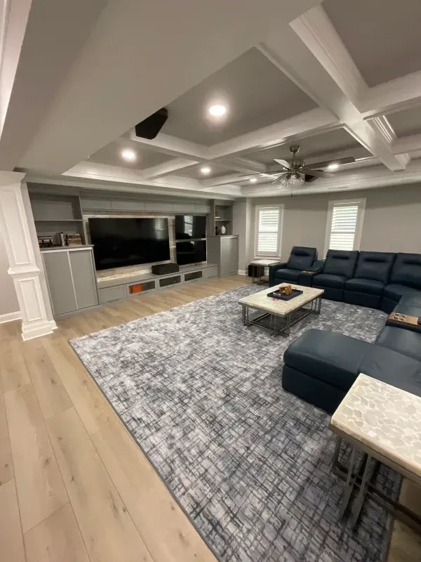 A living room with a couch , coffee table , and television.