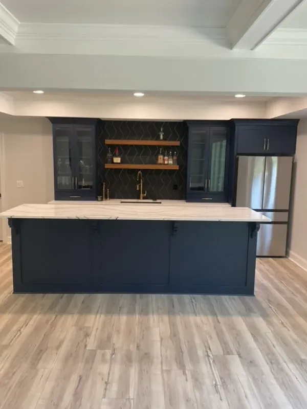 A kitchen with a large island and stainless steel appliances