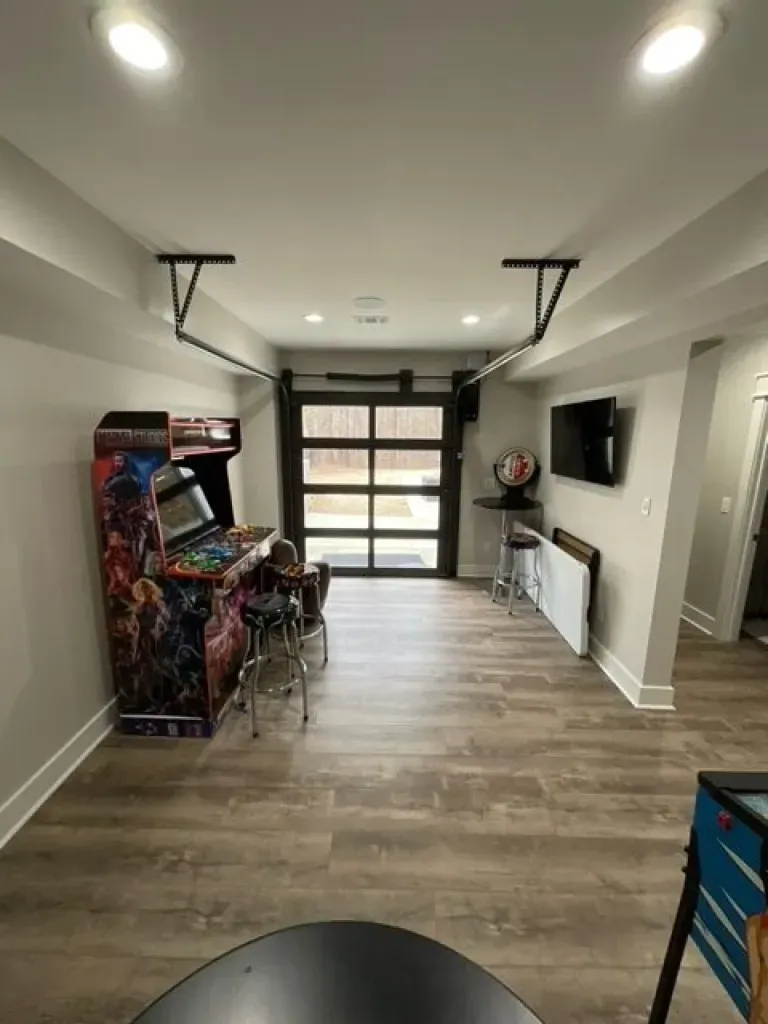 There is a game machine in the middle of the room.