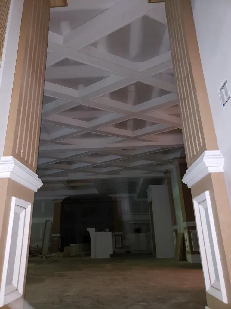 A large room with a ceiling that has a grid pattern