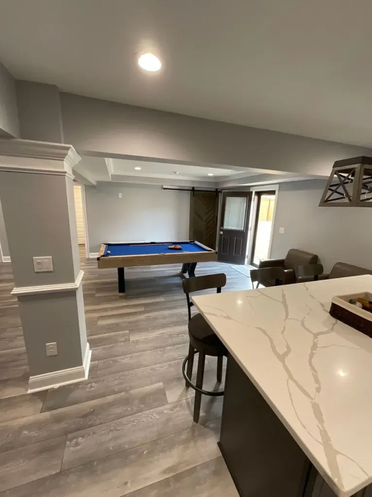 There is a pool table in the middle of the room.