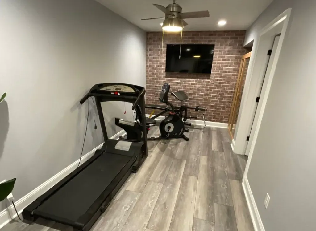 There is a treadmill and a bike in the room.