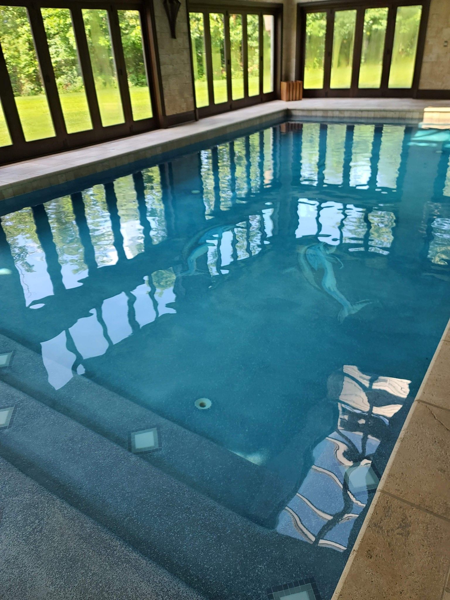 An indoor pool inside a sun room