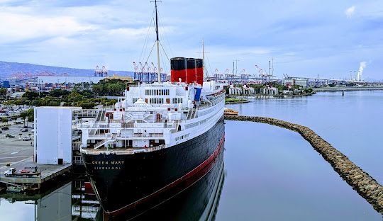 Side view of Queen Mary in Long Beach presented by party bus rentals Long Beach.