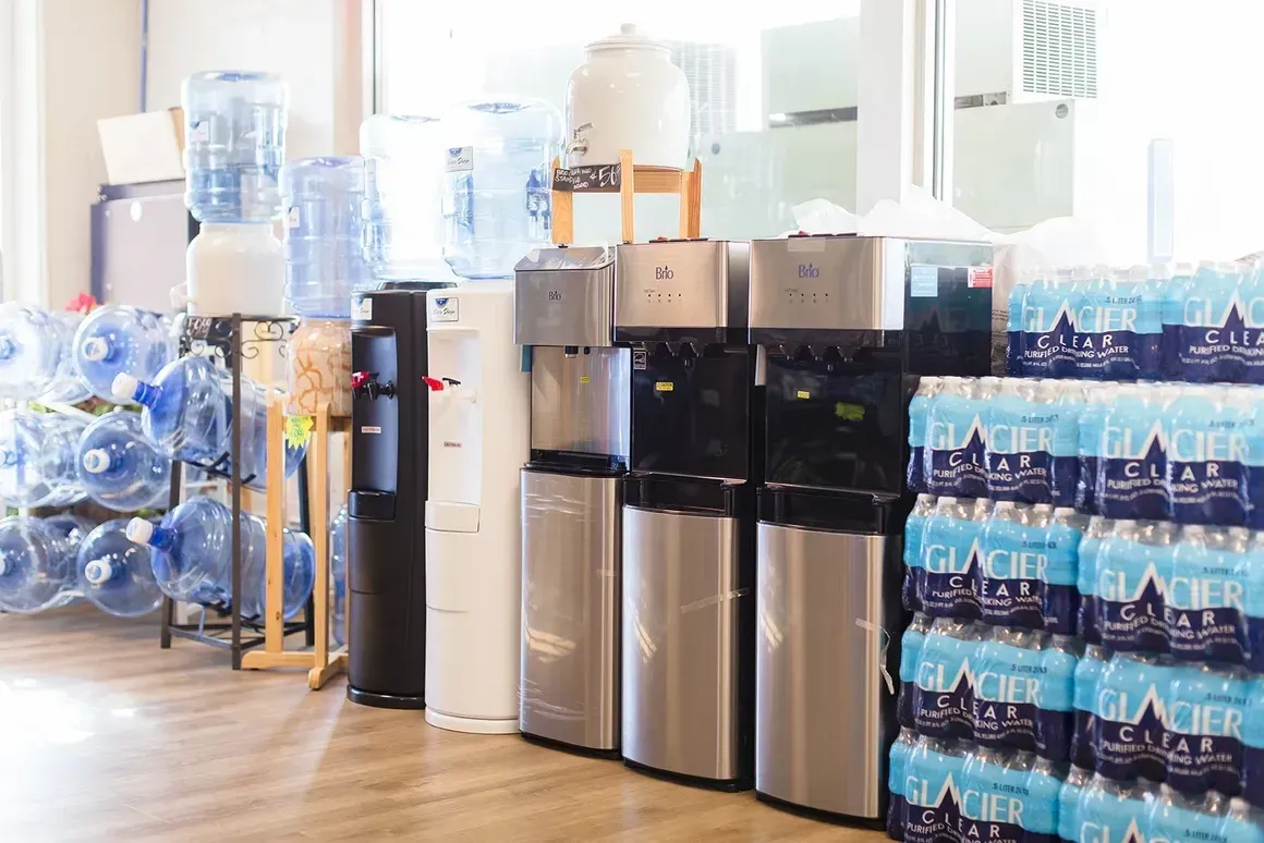 A room filled with water coolers and bottles of water.
