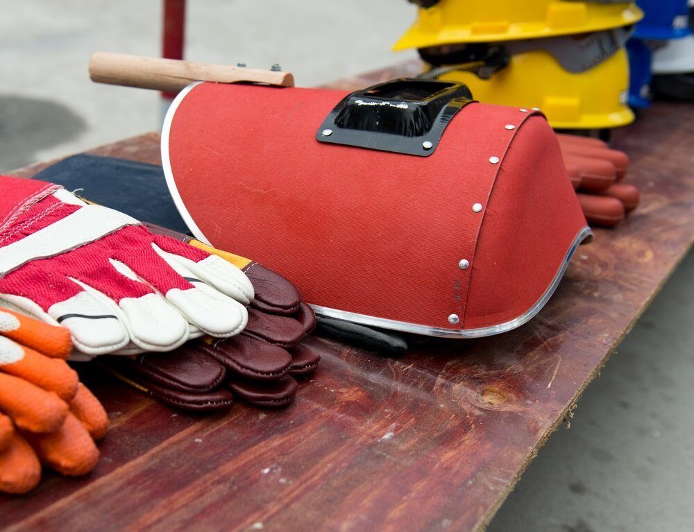 A Row Of Hard Hats And Gloves On A Wooden Table — Summerland Tool Supplies In Casino, NSW