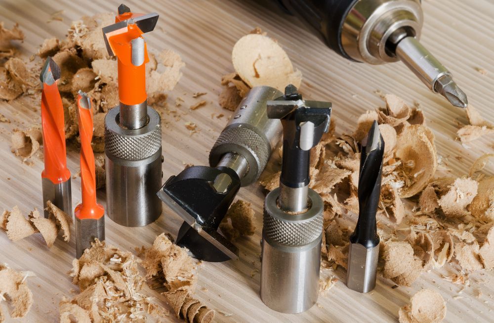 A Drill Is Sitting On A Wooden Table Next To A Bunch Of Drill Bits — Summerland Tool Supplies In Casino, NSW