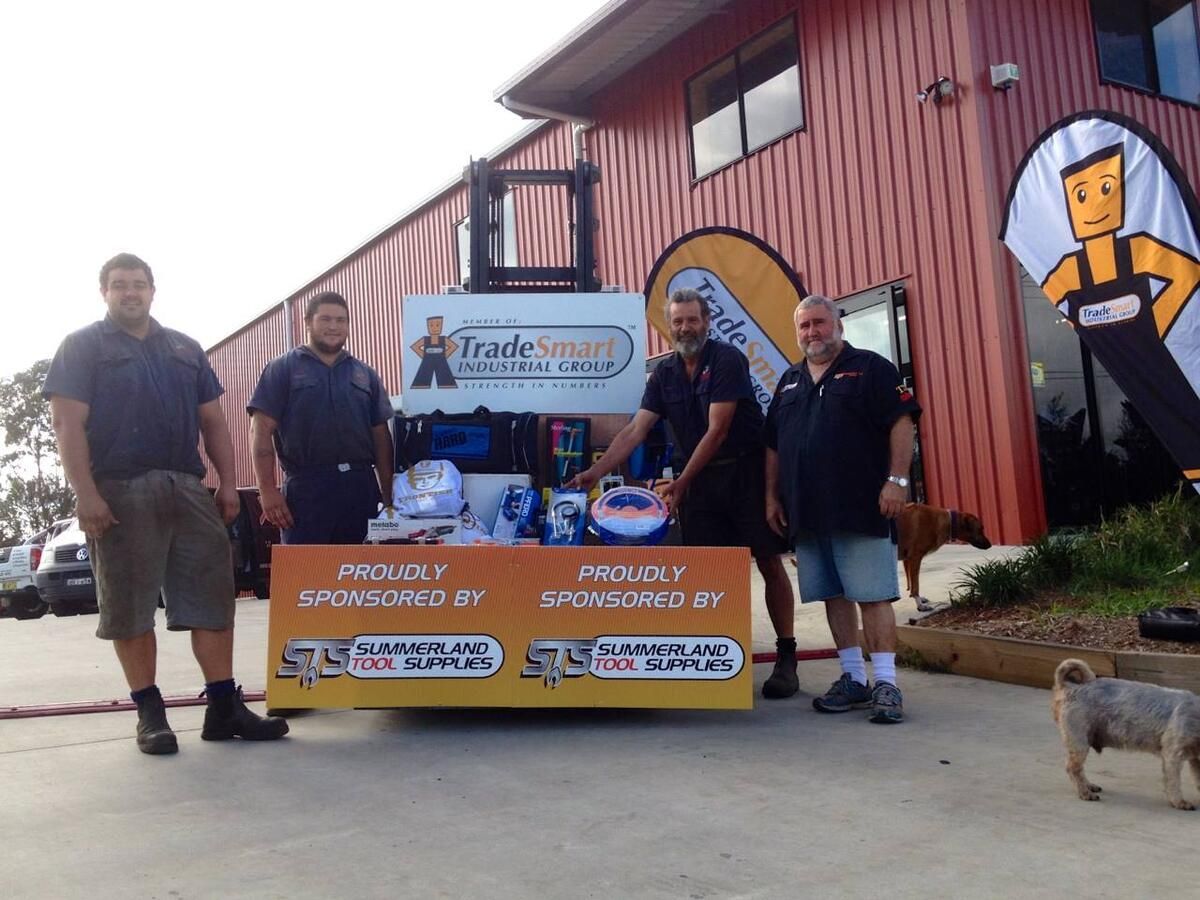 A Group Of Men Standing In Front Of A Sign That Says Trusted — Summerland Tool Supplies In Casino, NSW
