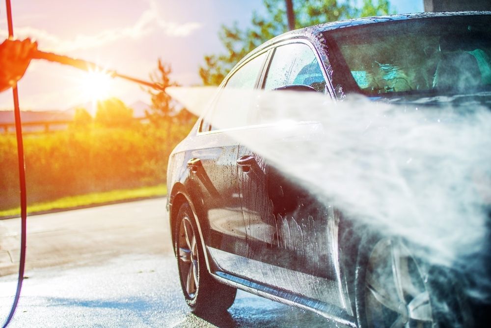 A Person Is Washing A Car With A High Pressure Washer — Summerland Tool Supplies In Casino, NSW