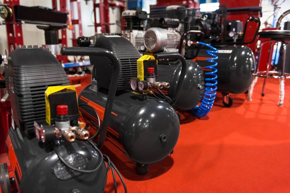 A Row Of Air Compressors Are Lined Up In A Room — Summerland Tool Supplies In Casino, NSW