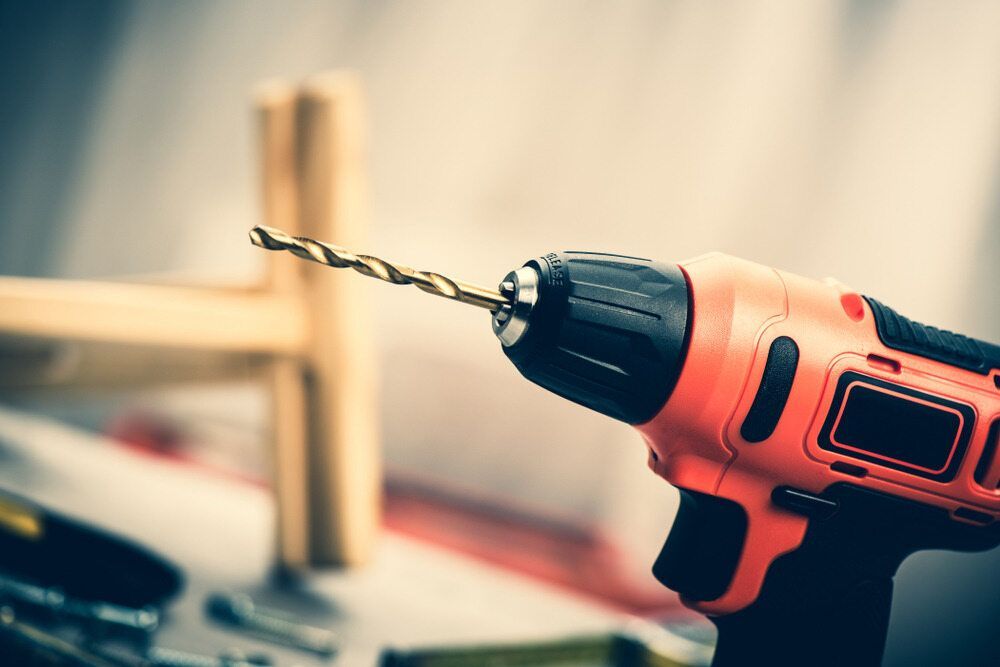 A Drill Is Being Used To Drill A Hole In A Piece Of Wood — Summerland Tool Supplies In Casino, NSW