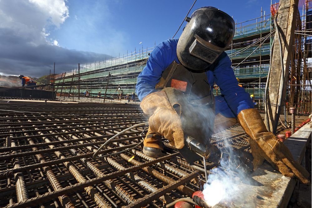 A Man Wearing A Welding Mask Is Welding A Metal Structure — Summerland Tool Supplies In Casino, NSW