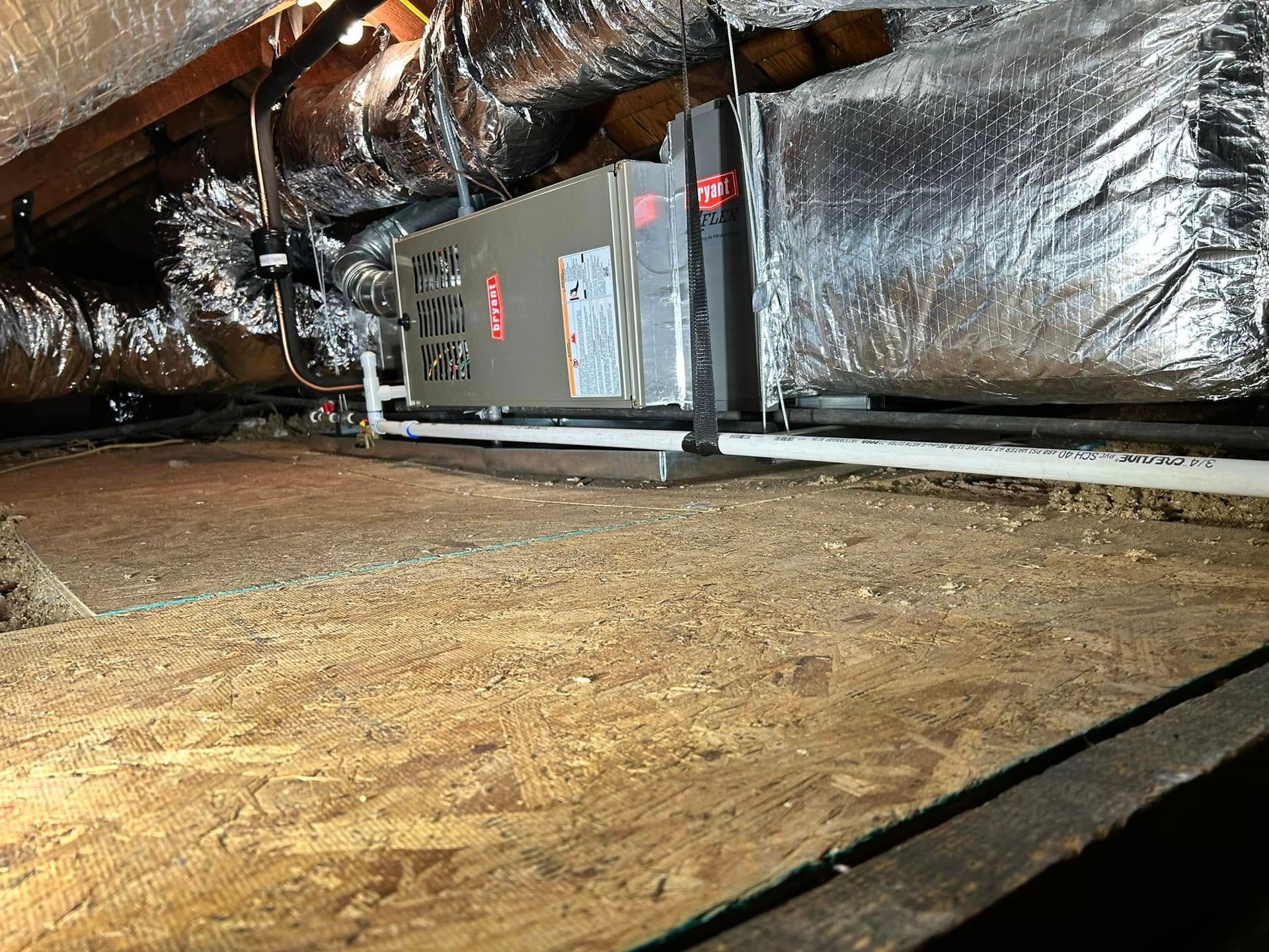 An air conditioner is installed in the attic of a house.