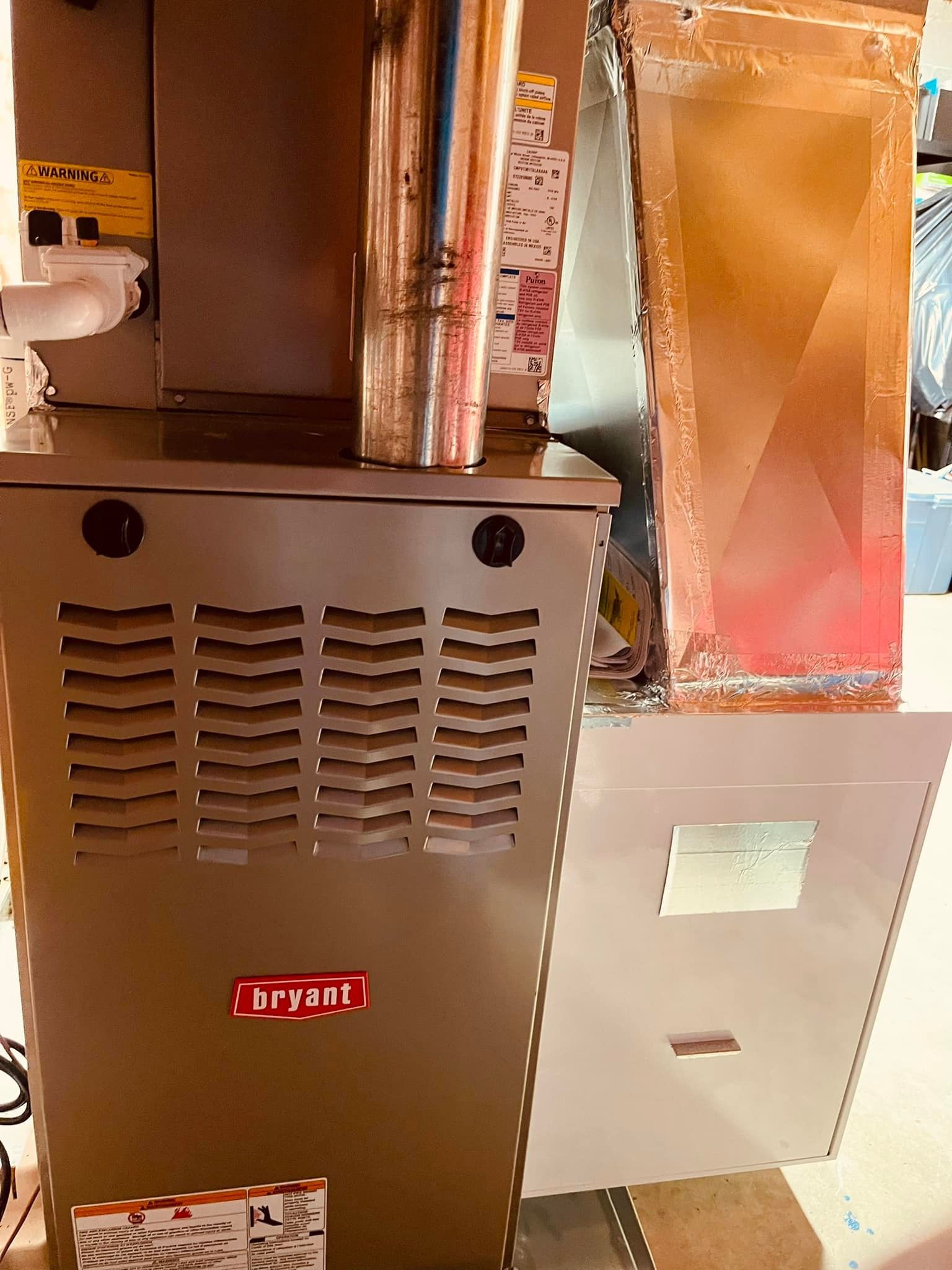A stainless steel air conditioner is sitting on top of a white cabinet.