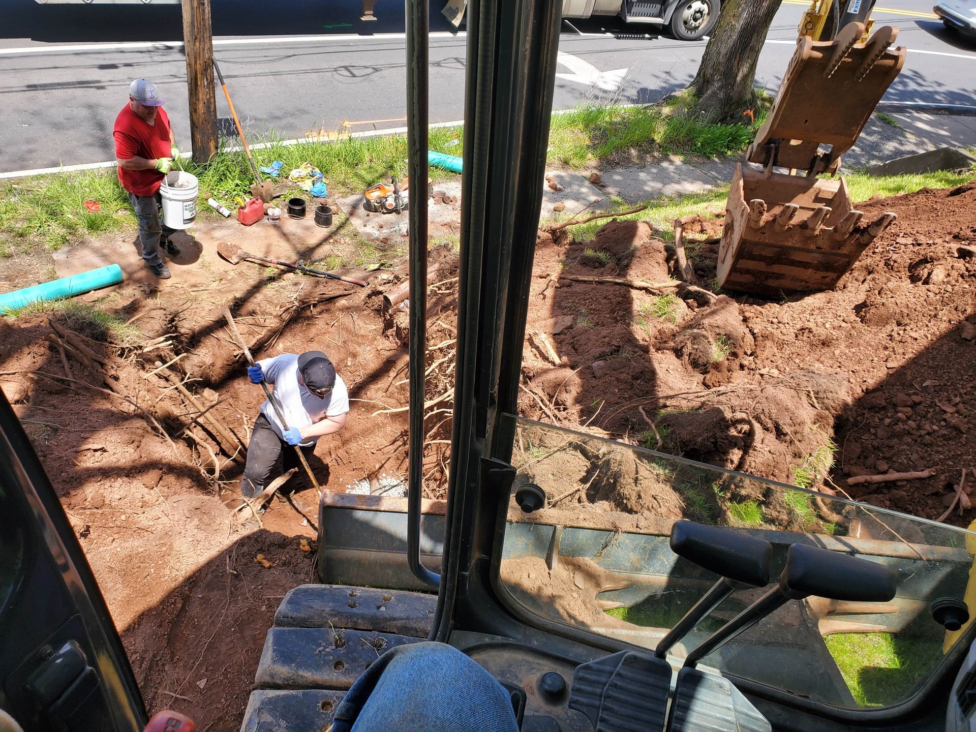 A man is digging a hole in the ground with a shovel.