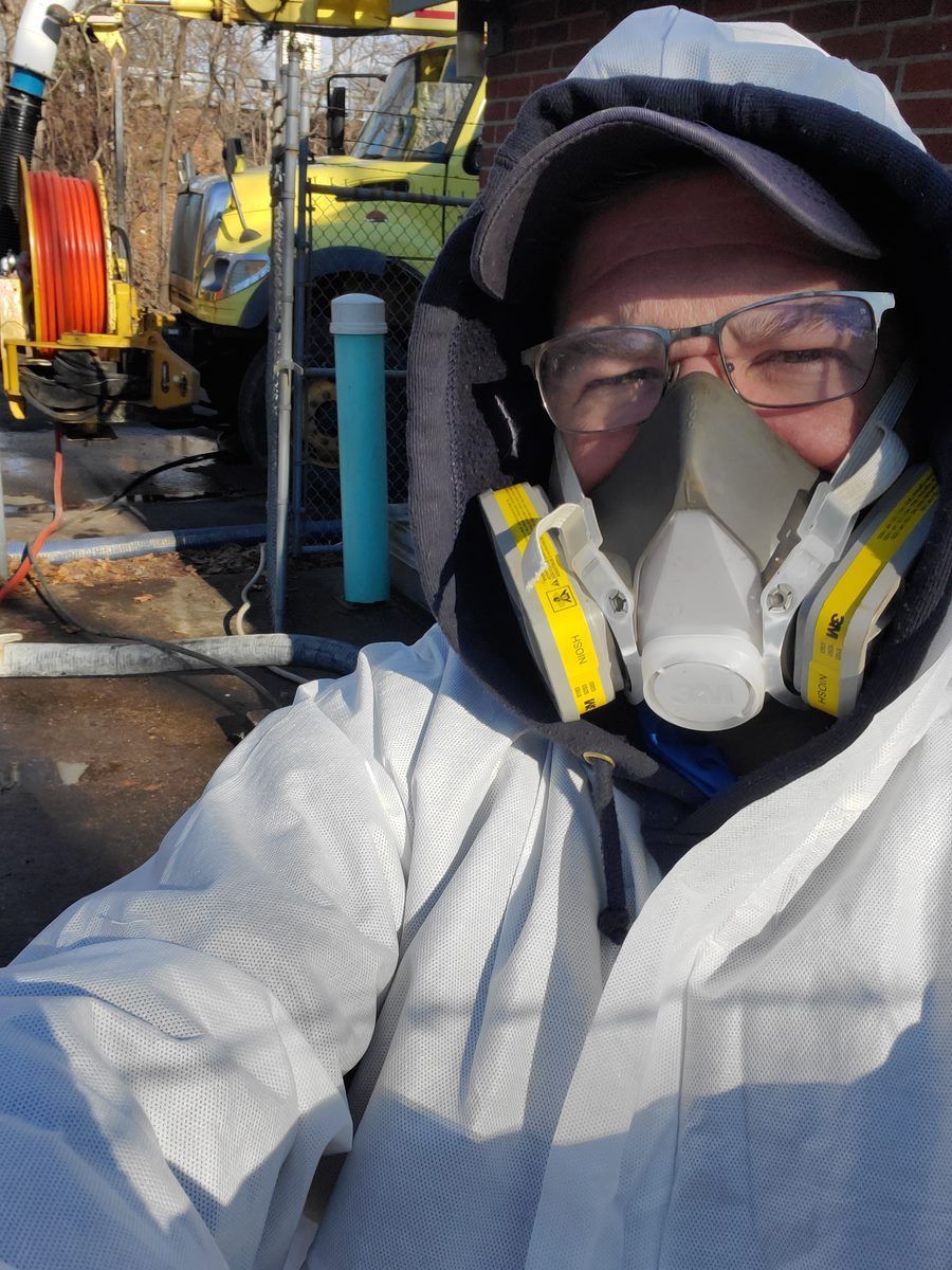 A man wearing a gas mask and safety glasses