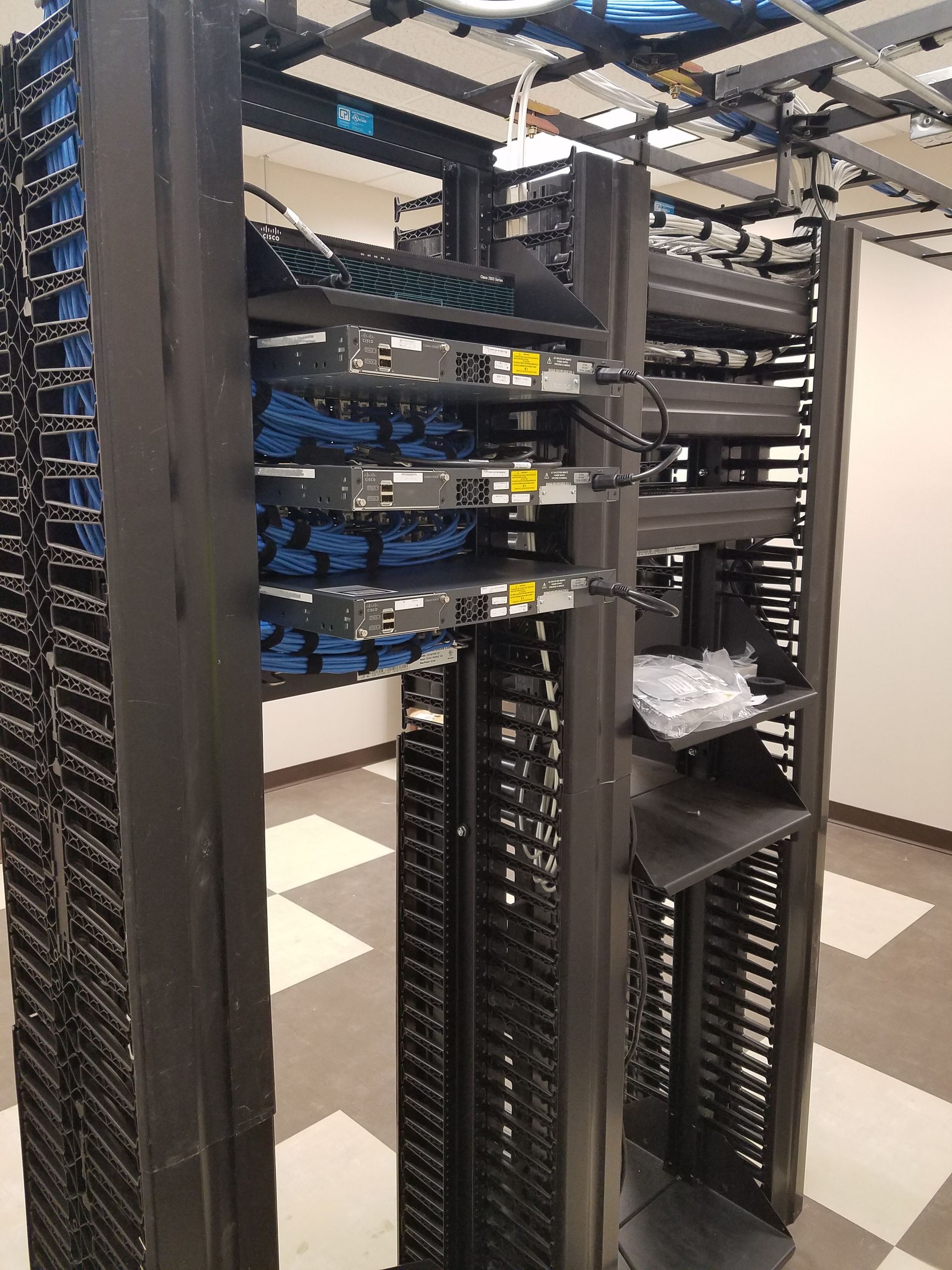 A server room with a lot of racks and shelves
