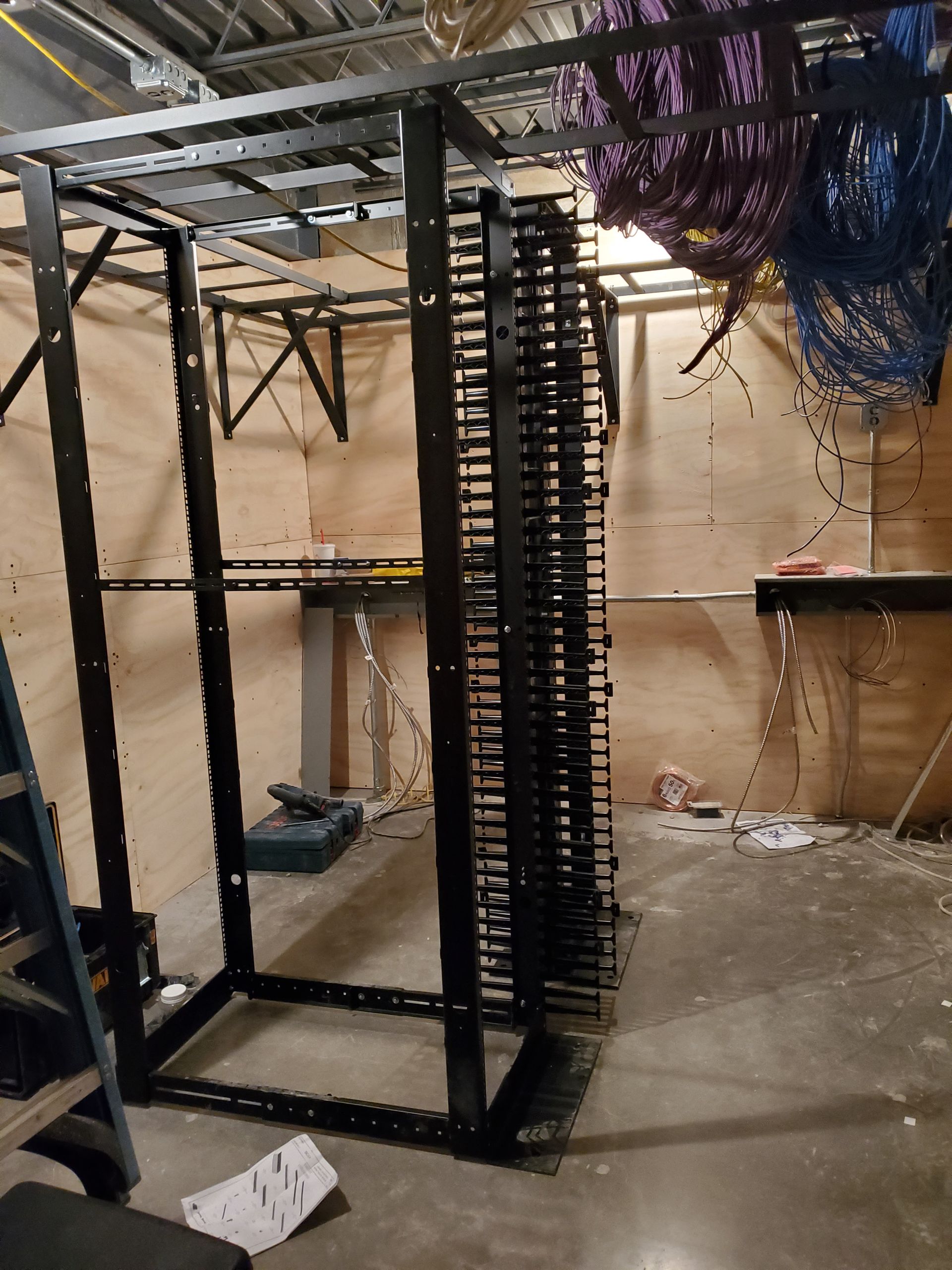 A ladder is sitting next to a rack in a room