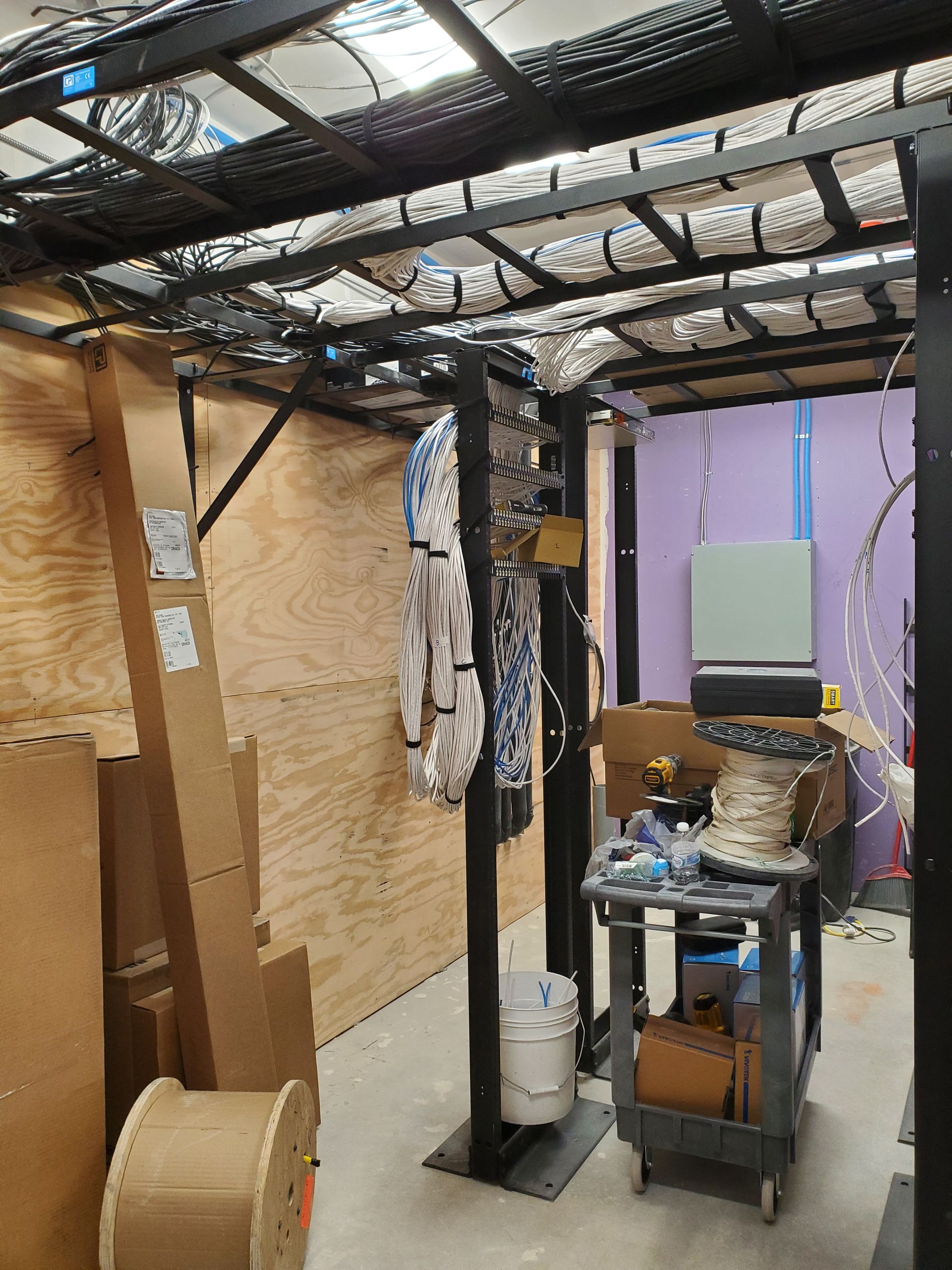 A room with a lot of wires hanging from the ceiling.