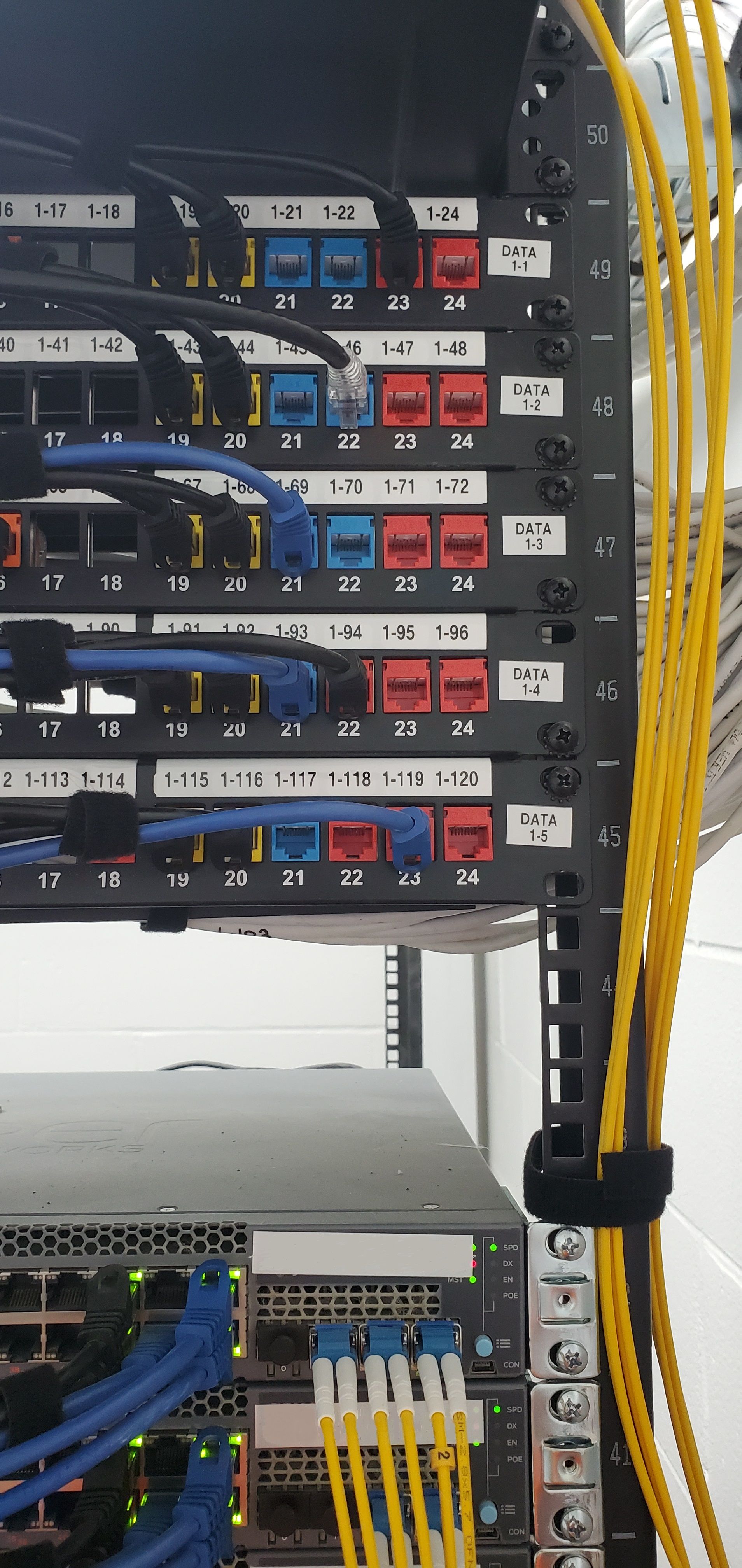 A server rack with a bunch of wires coming out of it.