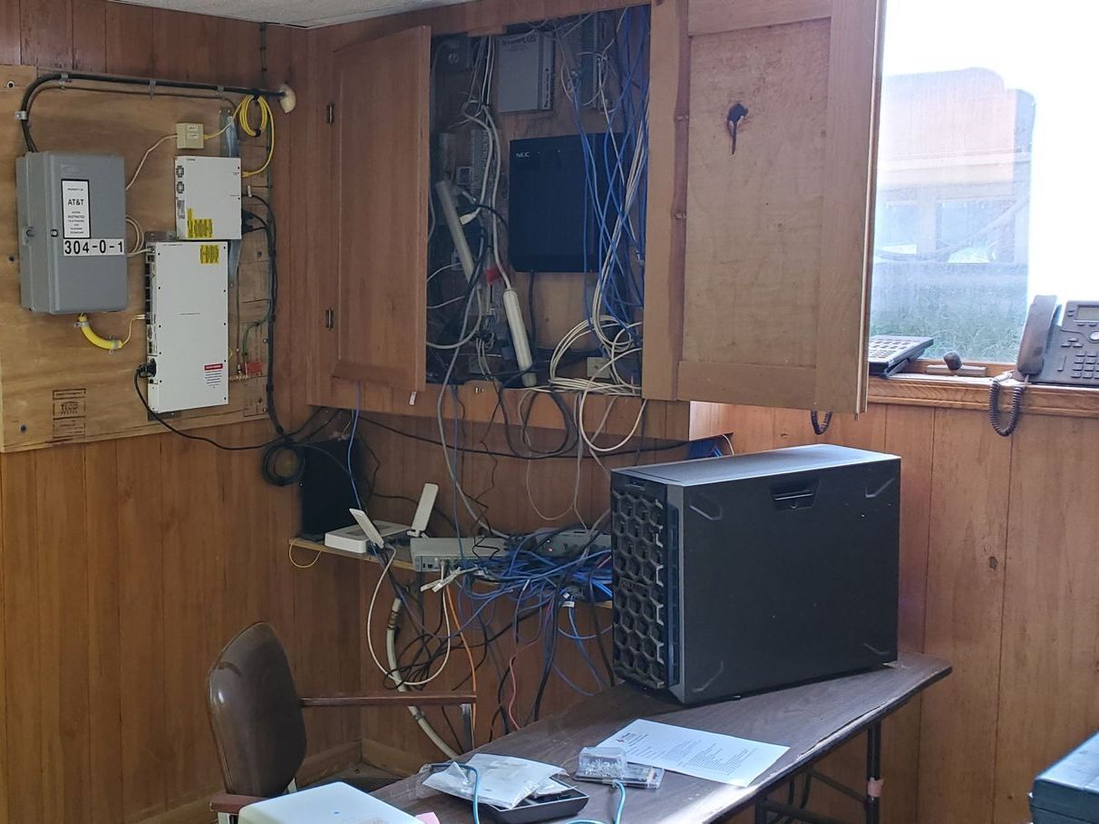 A room with wood paneling and a computer on a desk.